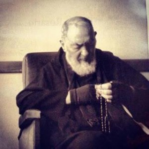 Pio praying rosary
